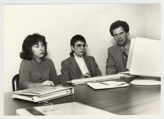 Gail Kennedy (left) and Mike Lach sit with an unidentified woman at a computer; Submitted for use the the 1983 / 1984 annual Report