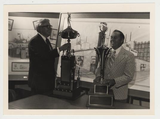 Charles Atcher and Cecil Bell with two trophies at the Adolph Rupp museum; Photographer: Jim Host & Associates