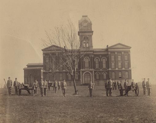 Cadets with two cannons in front of Administration Building; building features a rounded cupola