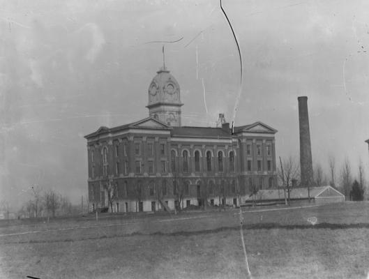 Administration Building, with rounded cupola; smoke stack in foreground, Gillis Building to the right