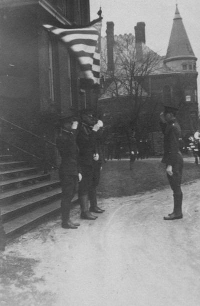 Cadets saluting in front of Administration Building; Gillis Building is to the right
