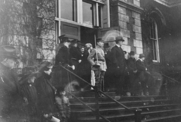 Group of people in front of the Administration Building; man on far left, top of stairs (with white beard) is James K. Patterson (UK President, 1878-1910), man standing next to cadet is Frank L. McVey (UK President, 1917-1940)