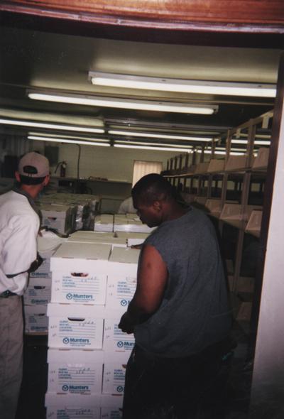 Administration Building fire, May 15, 2001; two unidentified men unloading preserved records into the temporary housing at Upper and Pine Streets