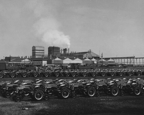 Rows of Farmall tractors lined up, possibly outside the International Harvester plant in Milwaukee; Agricultural Experiment Station Information Department photo