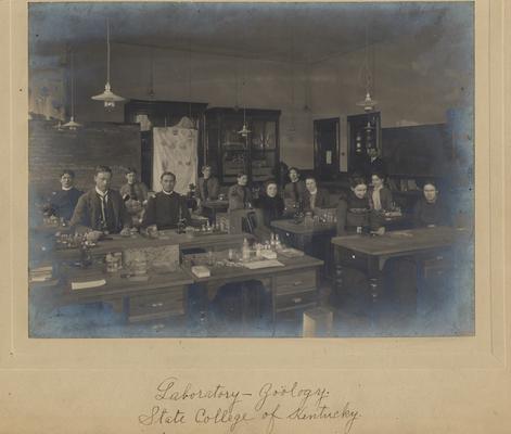 A zoology laboratory with Professor M. Miller standing by the door. This building is now Miller Hall. W. P. Johnson class of 1901 is the first person in the front row on the left side