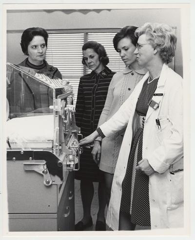 Dr. J. Noonan and three unidentified women look at the neonatal unit