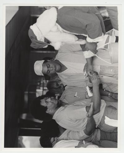 Santa Claus giving out candy to a group of men