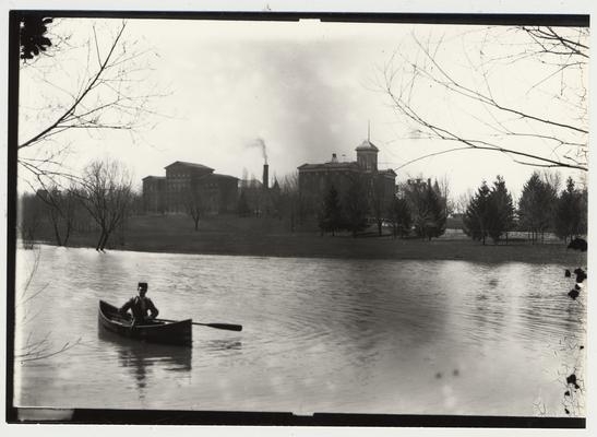 University of Kentucky military training during World War I.  A man in a canoe on the lake near the Administration building