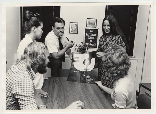 In 1971 Vince Davis became the director of the Patterson School of Diplomacy and International Commerce.  Vince Davis is discussing the World conference on Women with four unidentified individuals