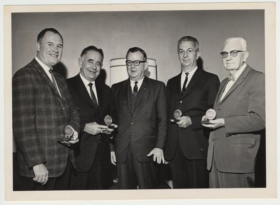 President John Oswald (second from left) and three other men are recipients of an award from the Land Bank