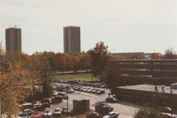 A color photo of the Blanding and Kirwan Towers (in the background towards the left), Commonwealth Stadium C. M. Newton Field (in the background to the right), Haggin Dormitory (towards the front on the right), and K-Lair Grill (on the right, in front of Haggin Dorm). This photo was taken in the fall of 1996 by Terry Warth