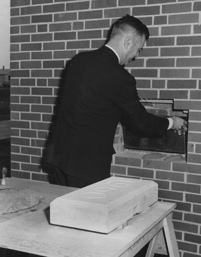 President Frank Dickey getting ready to put the 1960 block on Blazer Hall. This photograph received October 16, 1960 from Public Relations
