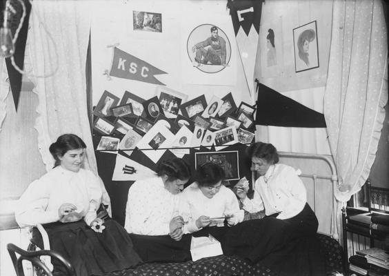 Four unidentified women in a dorm room in 1908. During this time there were four to five women in a room and lights-out by 10 or 11p.m. Photographer: R. R. Rodney Boyce and Associates
