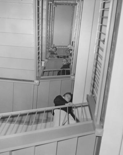 Five unidentified men in the stairway of a dorm