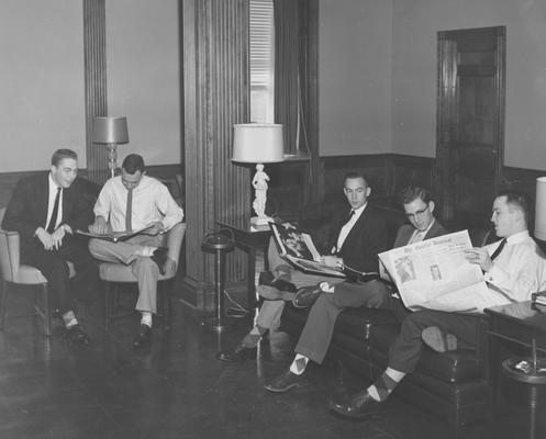 Five unidentified men sitting and socializing inside Bowman Hall