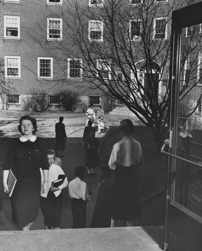 Unidentified women are to and from Boyd Hall, a woman's dormitory. Boyd Hall was built in 1925 and was named after Cleona Boyd