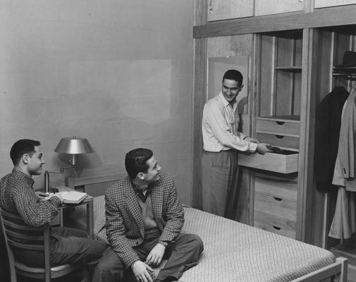 Three unidentified men are talking in a bedroom of Donovan Hall