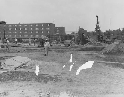 Unidentified men are working on the construction of Haggin Hall. Haggin Hall was named after James B. Haggin and dedicated on September 16, 1960. Received July 31, 1959 from Public Relations