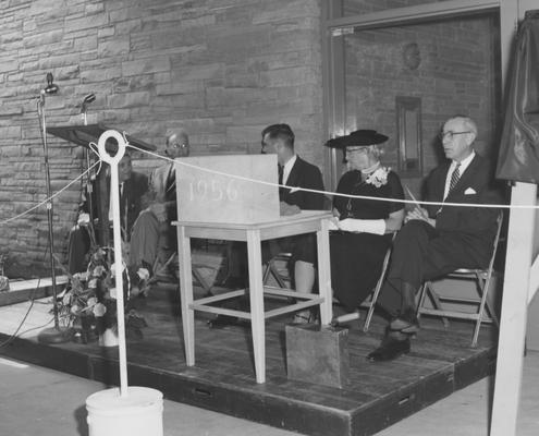 President Frank Dickey (third from right), Sarah Bennett Holmes (Dean of Women, second from right), and three unidentified men are seated on stage at the dedication of Holmes Hall on May 25, 1958. Received May 25, 1958 from Public Relations