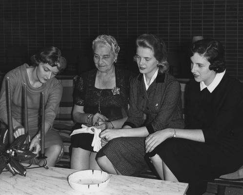 Katherine Maddox-Broadbent (second from right) and two unidentified women are seated with Sarah Bennett Holmes (second from left) in Holmes Hall. Received December 5, 1958 from Public Relations