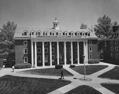 Unidentified students are near Kinkead Hall, a men's dormitory. Kinkead Hall was built in 1929 and was named after William B. Kinkead