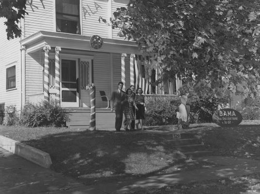 Mary Virginia Fulcher (far right) and three unidentified people are walking from the Delta Delta Delta house on 329 Aylesford Avenue. Received June 13, 1959 from the Cincinnati Enquirer