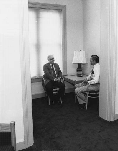 Two unidentified men sit inside a room at the Gaines Center