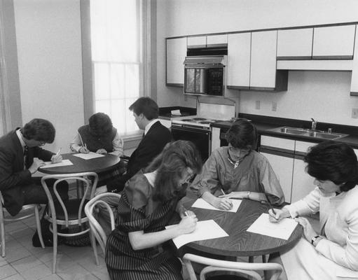 People sitting in a kitchen in the Gaines Center for Humanities. From left: (back table) Chris Pramuk, Regina Wink, unknown man. (front table) Lisa Rohleder, unknown woman, Fran Stewart