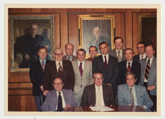 Department heads in the Board of Trustees Board Room.  First Row:  A. D. Albright, Vice President of Institutional Planning; Otis Singletary; unidentified man.  Second Row:  John Darsie, Legal Counsel; unidentified man; Larry Forgy, Vice President for Business Affairs; Jim Ruschell, Acting Vice President for Business Affairs; unidentified man.  Third Row:  Stan Wall, Vice President Community Colleges; Peter Bosomworth, Chancellor of the Medical Center; Don Clapp, Vice President of Fiscal Affairs