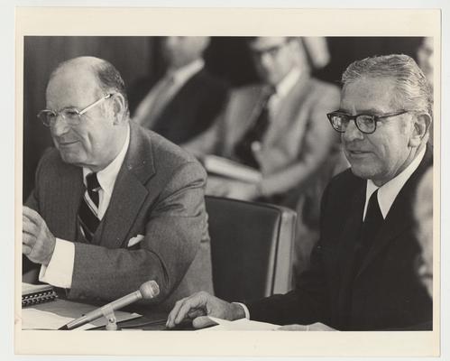 President Singletary (right) is seated next to William Sturgill (left) and is seated among others at an unidentified meeting