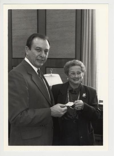 Harriett Rose, former faculty in Psychology Department and president of UK Association of Emeriti Faculty, gives a one thousand dollar check from the UK Association of Emeriti Faculty to President Charles Wethington for the Commonwealth library / William T. Young Library