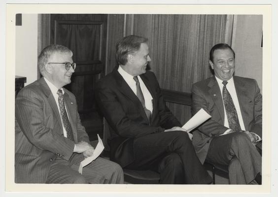 President Wethington is sitting and talking with two men.  From the left:  Paul Willis, Director of Libraries; Adkins, Vice President of Humana Corporation in Louisville, Kentucky; and President Wethington