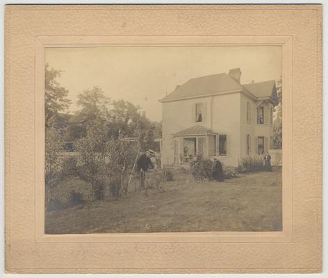James White is in his garden.  The picture shows the back of the White home on the corner of Maxwell Street and Harrison Avenue in Lexington, KY