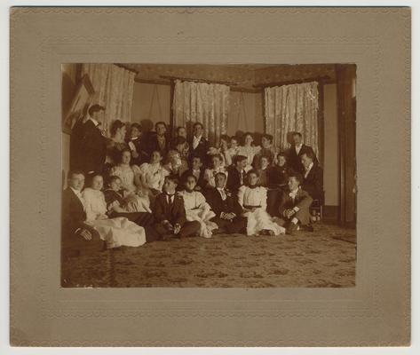 A group of unidentified people at the house of James G. White