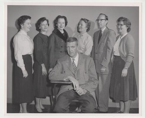 Seven unidentified people in an evening speech class which was part of University Extension.  University Extension was the forerunner to distance learning