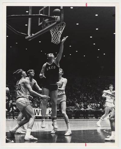 The University of Kentucky College of Dentistry Basketball team versus the University of Kentucky Freshman basketball team.  Cliff Berger.    From the left:  Jimmy Dan Conner (#20), Bob Guyette, unidentified UKCD player, G.J. Smith, and Keven Grevey (#35)