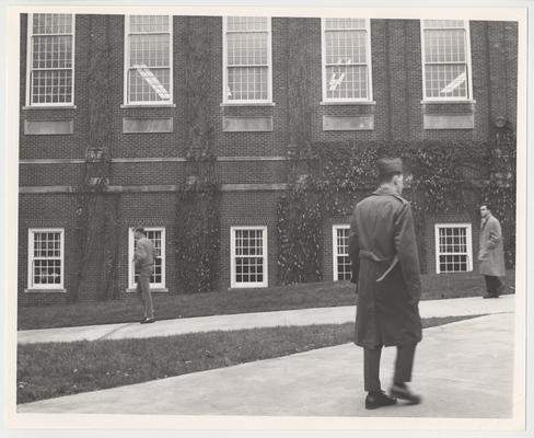 Three unidentified men walking past Margaret I. King Library