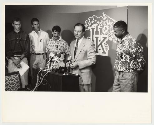 John Pelphrey (far left), Deron Feldhaus (second from left), Richie Farmer (third from left) and Sean Woods (right) are listening to UK President Charles Wethington (second from right) talk to the press