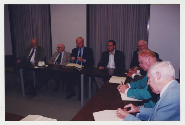 Lowell Harrison (far right), William Ellis (second from right), James Klotter (third from right), James Duane Bolin (center), John Keber (third from left), Charles Roland (second from left), and Edward Coffman (far left) are seated at a table at Dr. Thomas D. Clark's 100th birthday celebration at Young Library