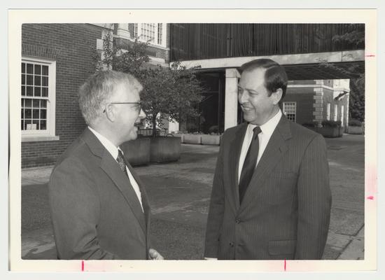 President Charles Wethington (right) is talking with Paul Willis (left), Director of Libraries, near M. I. King Library