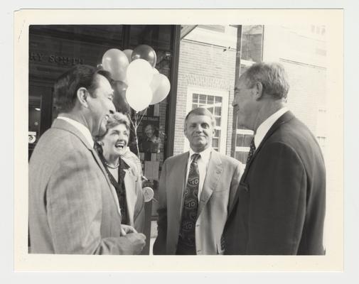 Athletic Director C. M. Newton (right) is talking with Vice President Gene Williams (second from right); Carolyn Curry (second from left), Professor of Women's Studies and spouse of Football Coach Bill Curry; and President Charles Wethington (right)