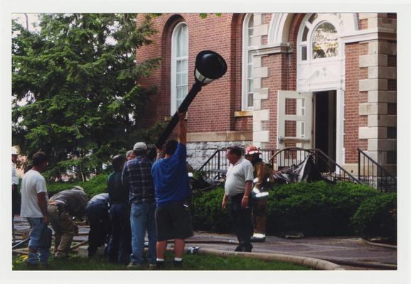 Unidentified men are helping during the fire in the Administration / Main Building