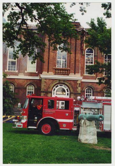 A fire truck is outside of the Administration / Main Building during the fire