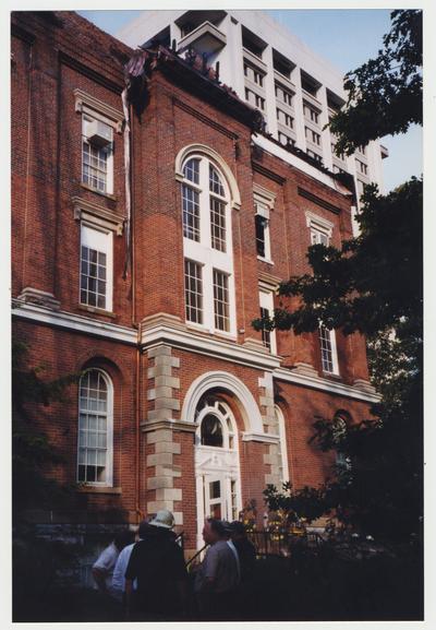 Unidentified men are standing outside of the Administration / Main Building after the fire was extinguished