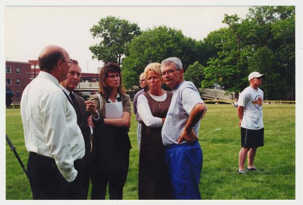 Left to right: Terry Birdwhistell, President Charles Wethington, unidentified female, Marian Sims, and Frank Burch stand outside the Administration / Main Building after the fire