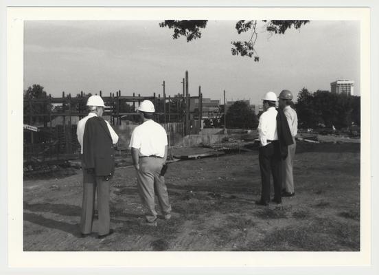 President Charles Wethington (second from right) is watching the construction of the William T. Young Library with three unidentified men