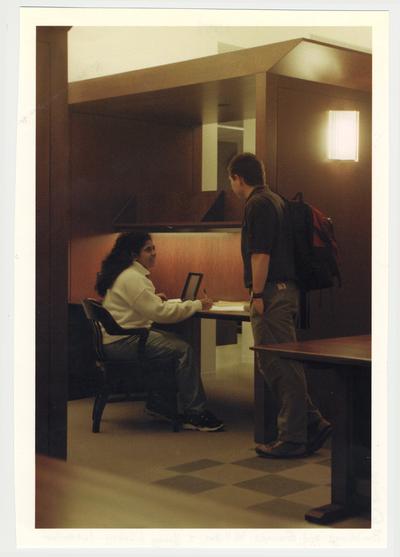 An unidentified male student (right) is talking with an unidentified female student (left) in the newly completed William T. Young Library