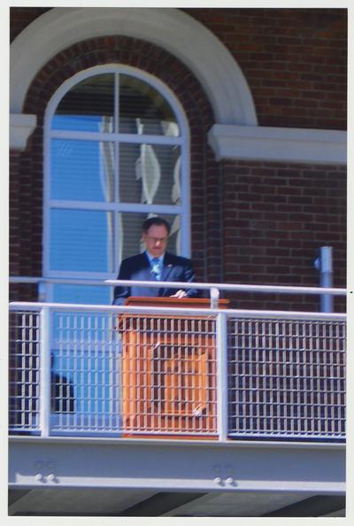 President Lee Todd is speaking from the balcony of the renovated Main Building after the fire, at the reopening of the Main Building