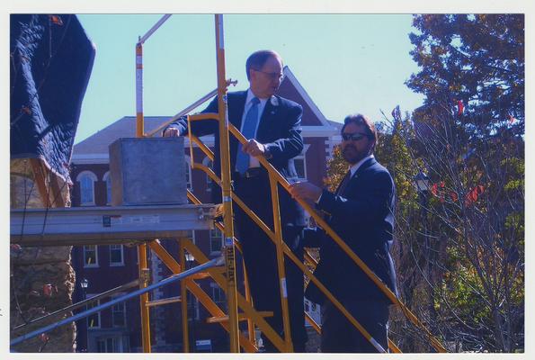 President Lee Todd (left) is talking to David Doss (right), with Messer Construction Company, during the ceremony for the reopening of the Main Building
