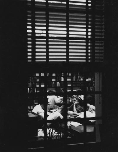 Students studying in the reserved Book Room on the first floor of the King Library Annex. Picture is taken from outside the window looking in. Received December of 1960 from Public Relations